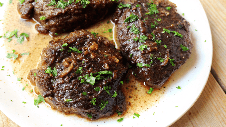 Tender braised beef cheek meat on with herb-infused sauce.