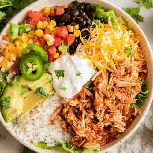 Creamy Crockpot Ranch Chicken: Easy Dump-and-Go Dinner! 2 Overhead view of a vibrant Crockpot Ranch Chicken burrito bowl, complete with fresh avocado, rice, and salsa.