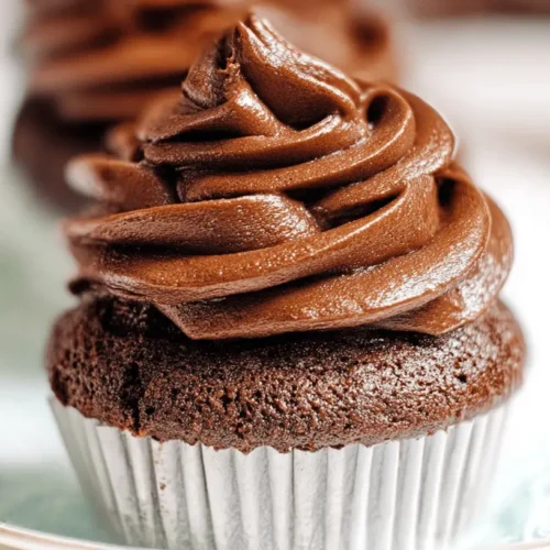 Easy, Creamy Chocolate Cake Frosting 2 Close-up of a chocolate cupcake with decadent chocolate cake frosting, elegantly piped.