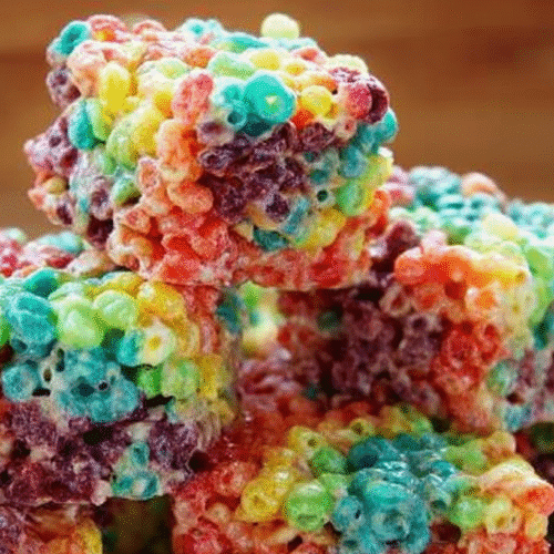 Vibrant Trix Krispie Treats: Easy No-Bake Cereal Bars 4 simple Trix Krispie Treats taken with an old camera, vibrant colorful rainbow cereal treats, sticky gooey marshmallows, glossy sheen, sweet chewy texture, soft diffused lighting, shallow depth of field, warm blurred background.