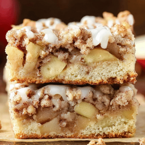 simple apple pie coffee cake taken with an old camera, delectable stacked apple crumb cake, close-up, warm lighting, golden-brown crumbly streusel, white glaze drizzle, tender diced apples, airy cake base, blurred rustic background, cinnamon sticks, scattered crumbs.