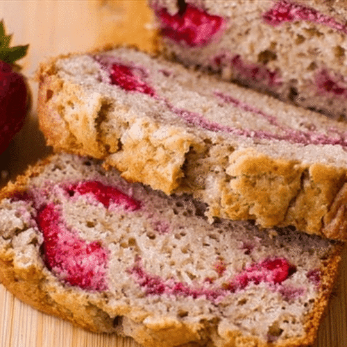 simple strawberry banana bread taken with an old camera, appetizing close-up, freshly sliced, stacked slices, golden-brown crust, moist crumb, bright red strawberries, fresh whole strawberry, light wooden surface, soft even lighting, homemade.